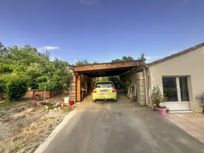 a yellow car parked under a garage at La maison de l'olivier in Saint-Saturnin-les-Apt