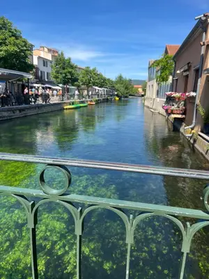 a view of a river from a bridge at Place ô sorgue ! in LʼIsle-sur-la-Sorgue