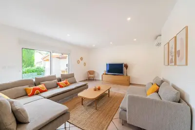 a living room with two couches and a tv at Villa & Piscine 8P entre Isle sur Sorgue et Avignon in Caumont-sur-Durance