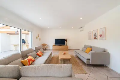 a living room with two couches and a tv at Villa & Piscine 8P entre Isle sur Sorgue et Avignon in Caumont-sur-Durance