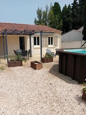 a backyard with a house and a swimming pool at Provencal-style villa in Morières-lès-Avignon