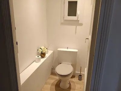 a white bathroom with a toilet and a sink at 2 bedroom apartment in the city center in Aix-en-Provence