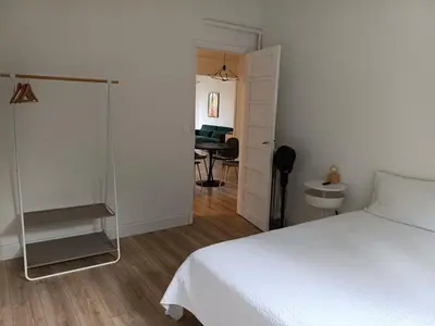a bedroom with a white bed and a desk at 2 bedroom apartment in the city center in Aix-en-Provence