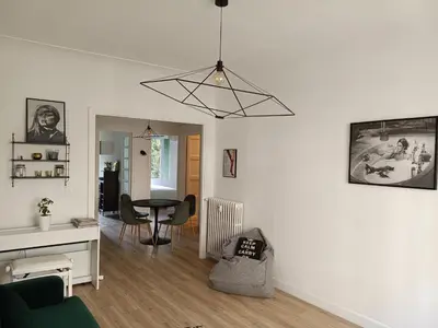 a living room with a table and a dining room at 2 bedroom apartment in the city center in Aix-en-Provence