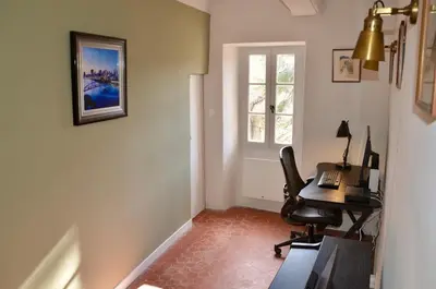 an office with a desk and a chair and a window at La Serre in Viens
