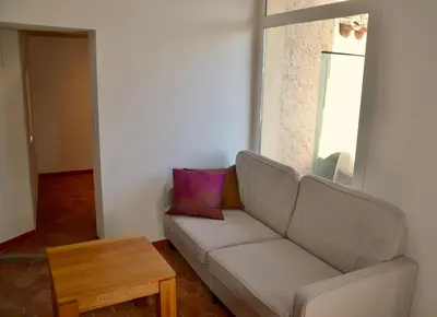 a living room with a couch and a table at La Serre in Viens