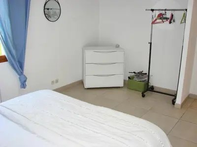 a bedroom with a bed and a dresser and a clock at beautiful 4 bedroom villa, pool, Luberon in Cadenet