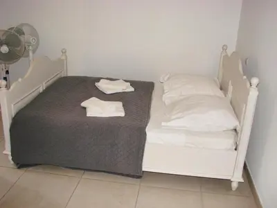 a white bed with two white towels on it at beautiful 4 bedroom villa, pool, Luberon in Cadenet