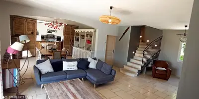 a living room with a blue couch and a staircase at le mas du luberon rouge in Cheval-Blanc