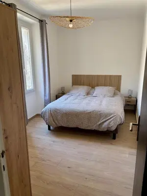 a bedroom with a bed and a chandelier at Appartement 100 m carré pour 6 à 8 personnes in Saint-Cannat