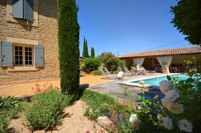 a villa with a swimming pool and a house at Le moulin vieux, mas authentique en Provence avec piscine in Entraigues-sur-la-Sorgue
