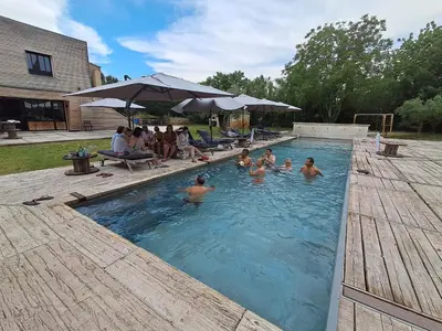 a group of people swimming in a swimming pool at Coeur des Hommes in Le Thor
