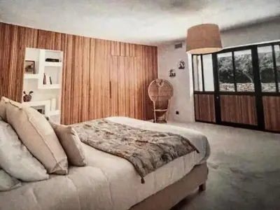a bedroom with a large bed and a large window at Coeur des Hommes in Le Thor