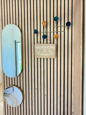 a mirror on a wall with a chair and a mirror at Charmants duplex , Clim et Piscine in Aix-en-Provence