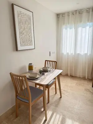 a dining room with a table and two chairs at Charmants duplex , Clim et Piscine in Aix-en-Provence