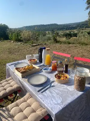 a table with food and drinks on it at La cabane - Nature et Spa in Aurons