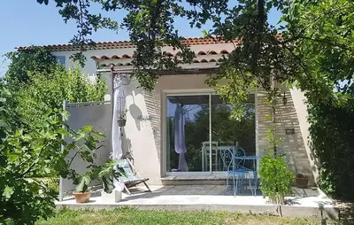 a small house with a window and a chair on a porch at Maison Avec Jacuzzi in Mazan