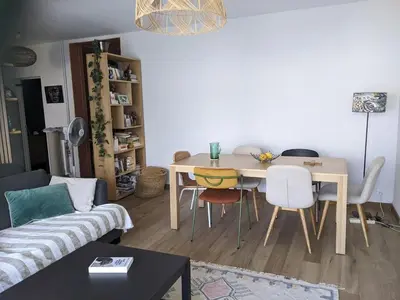 a living room with a table and chairs at Quiet cozy apartment in Aix-en-Provence