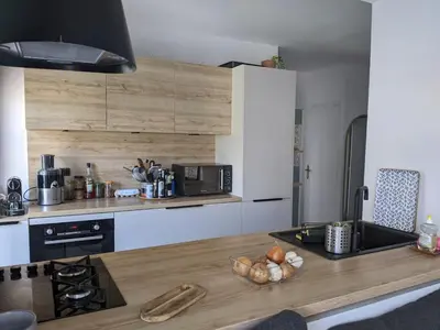 a kitchen with a wooden counter top with a microwave at Quiet cozy apartment in Aix-en-Provence