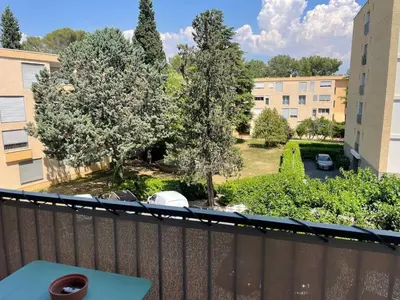 a cup of coffee on a table on a balcony at Quiet cozy apartment in Aix-en-Provence