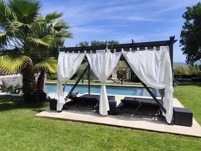 a gazebo with a canopy next to a pool at Aloha in Aix-en-Provence