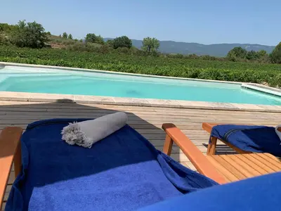a table and two chairs next to a swimming pool at Peaceful Studio With Private Pool In Luberon in Ansouis