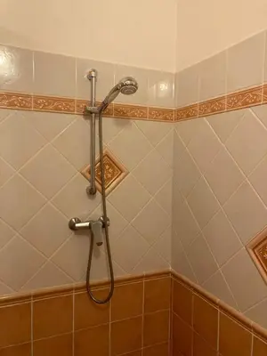 a shower with a shower head in a bathroom at Gite confort et Calme Casa La Piboulette in Carpentras