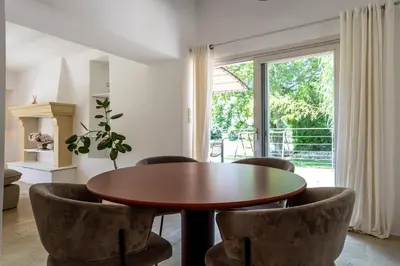 a dining room with a wooden table and chairs at Gîte Terrasse in Gordes