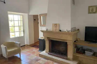 a living room with a fireplace and a television at La Rochère - Hamlet with swimming pool in Gordes in Gordes