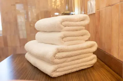 a stack of towels sitting on a table in a bathroom at Terres Élaïs in Robion en Luberon