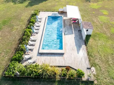 an overhead view of a swimming pool on a wooden deck at La Bastide des Amouriers in Caumont-sur-Durance