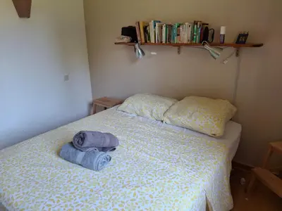 a bedroom with a bed with a towel on it at Maison familiale Luberon in Lauris