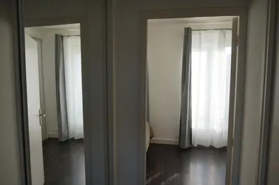 a mirror in a room with a window at Appart Suite Privilege XL avec Parking in Salon-de-Provence