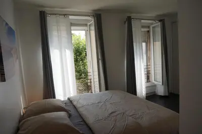 a bedroom with a bed in front of a window at Appart Suite Privilege XL avec Parking in Salon-de-Provence