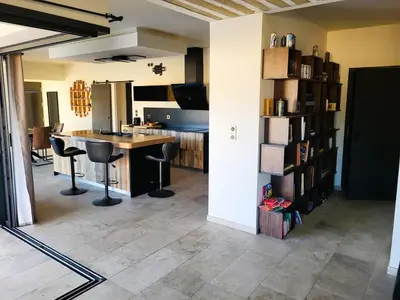 a kitchen with a table and chairs in a room at Friendly and warm villa with pool in Pernes-les-Fontaines