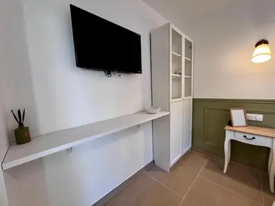 a living room with a tv on a wall at Studio Avignon MONTFAVET in Avignon