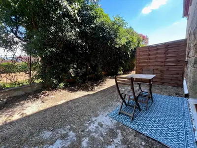 a bench sitting on a blue rug next to a table at Studio Avignon MONTFAVET in Avignon