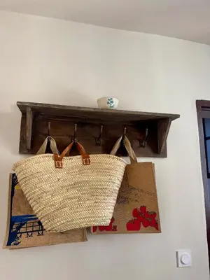 a shelf with two bags and boxes on a wall at Charming house in the village center of Venasque in Venasque