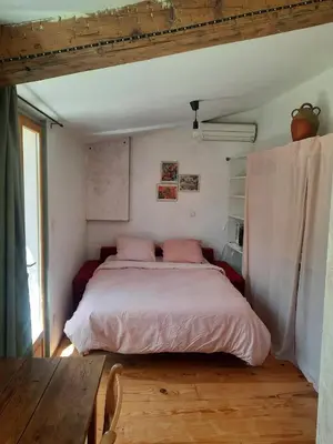 a kitchen with a wooden table and a kitchen with a tableablish at Petit studio avec jardin à 10 mn d'Avignon in Entraigues-sur-la-Sorgue