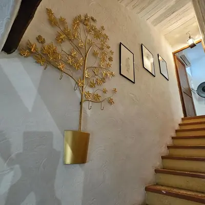 a plant in a vase on a wall at Maison au Cœur de Isle-sur-la-Sorgue in LʼIsle-sur-la-Sorgue
