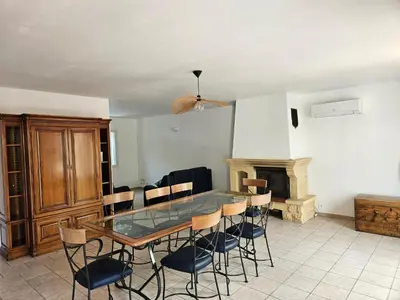 a dining room with a glass table and chairs at Villa de la Goutte d'Or in Caromb