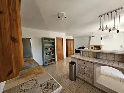 a kitchen with a counter and a sink and a counter top at Villa de la Goutte d'Or in Caromb