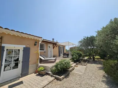 a house with a porch and a patio at Villa de la Goutte d'Or in Caromb