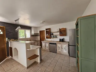 a kitchen with a white counter top in a room at Villa de la Goutte d'Or in Caromb