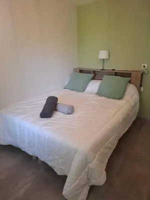a large white bed in a room with a lamp at Gîte dans un mas Provençal - L'Oustalet in Saint-Andiol
