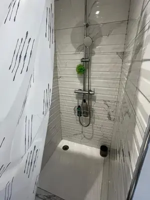 a bathroom with a shower with a tub at Chambre d'hôtes in Carpentras