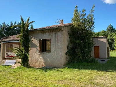 a small house in a field next to a tree at Villa de l'Argau in Revest-du-Bion