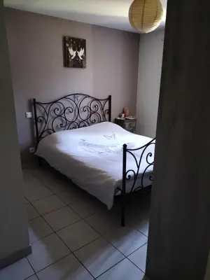 a bedroom with a large bed with white sheets at L infiniment zen in Caromb