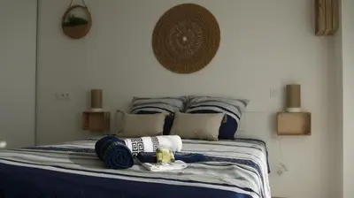 a bed with blue and white sheets and pillows at Studio Business Wi-Fi 7 TVA Proche zones LesMilles La Duranne Aix TGV in Éguilles