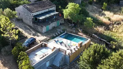 an aerial view of a house with a swimming pool at Les terrasses des pourquiers in Gordes